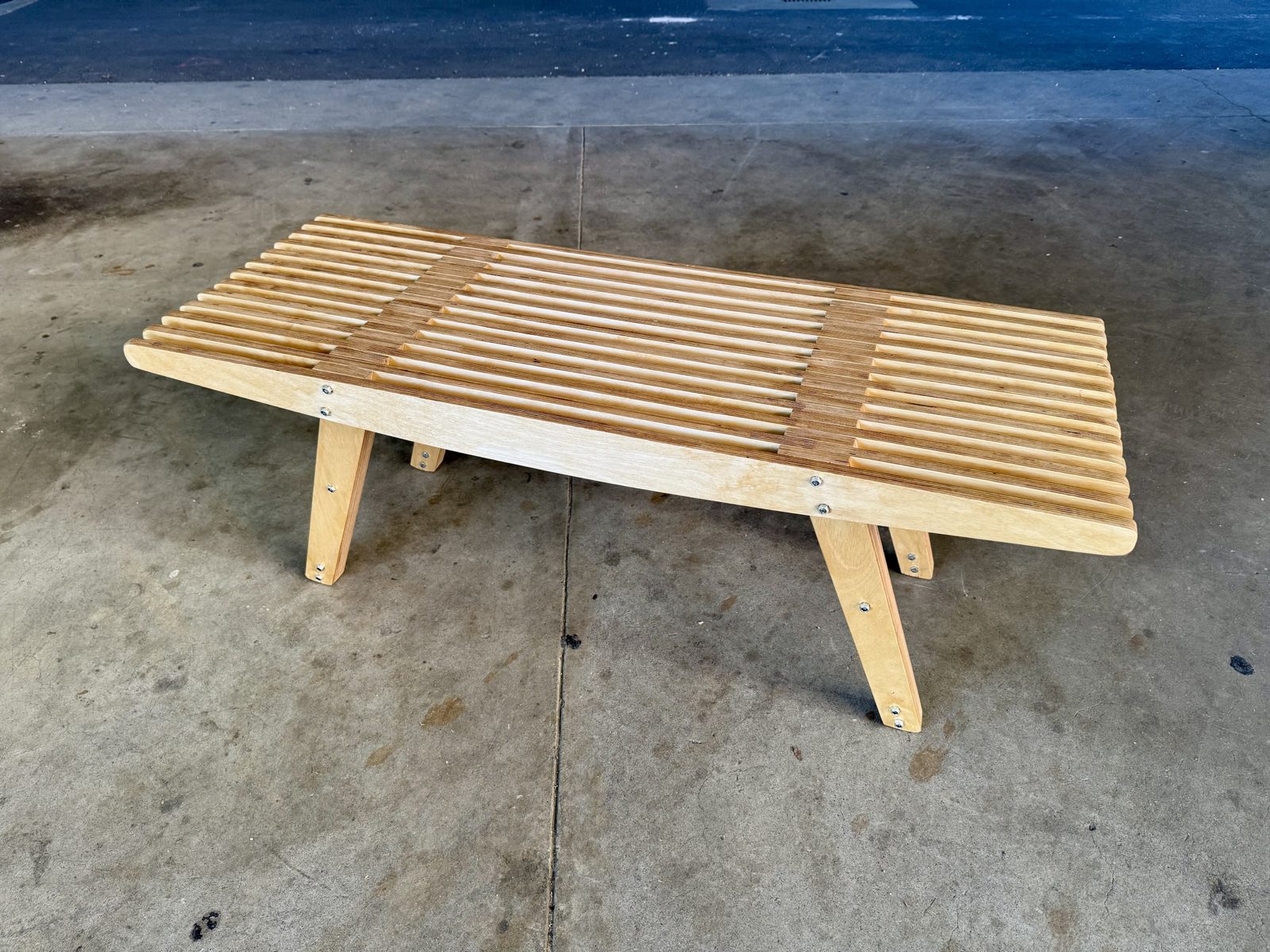 The bench from above at an angle, the cross pieces interlocking with the slats